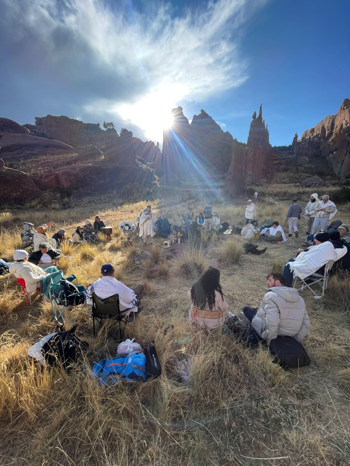 Ayahuasca ceremony at Amaru Muru, Peru — group seated among rock formations at sunset