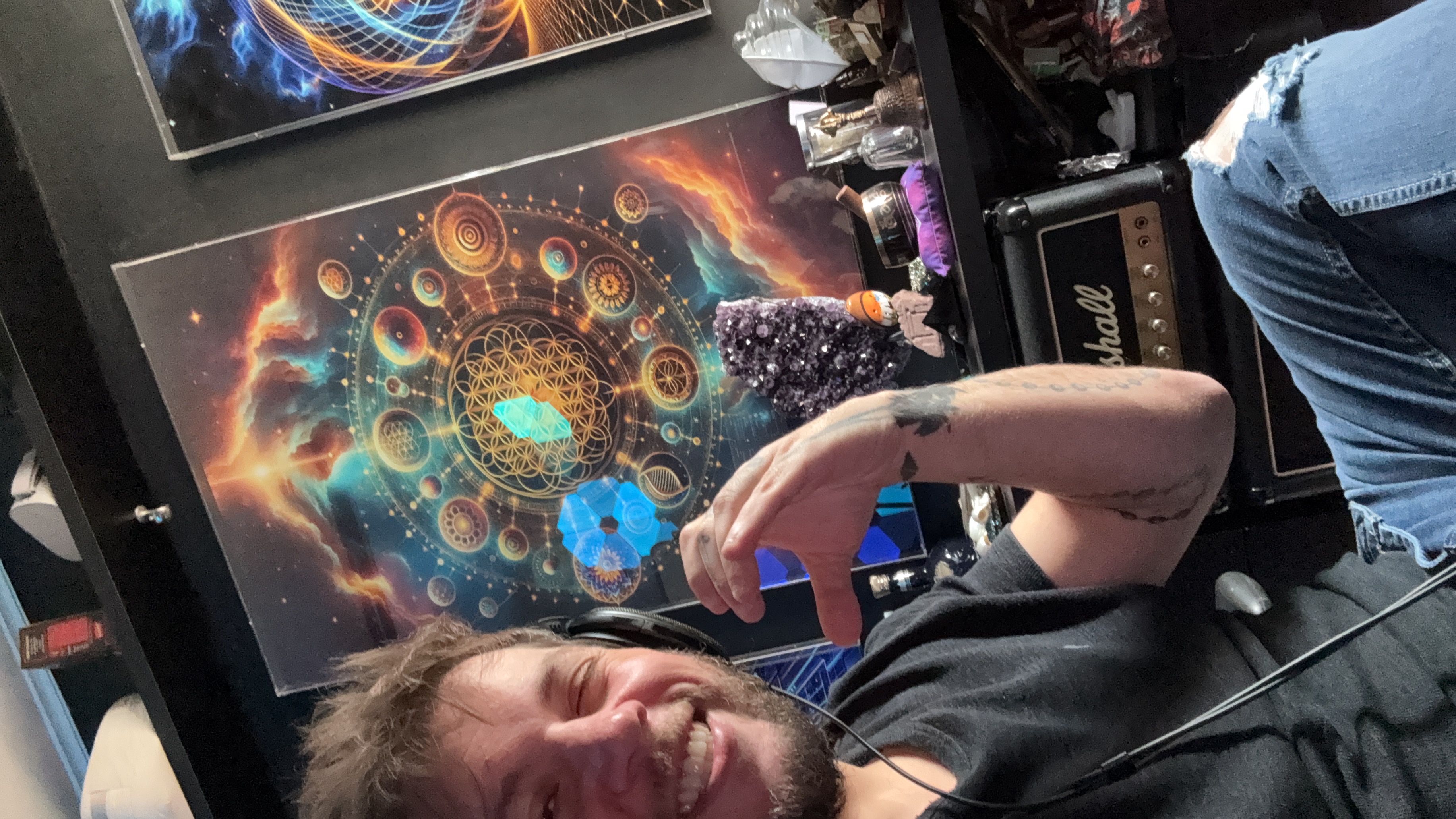 Wilton at his desk — sacred geometry art, amethyst, headphones, Marshall amp